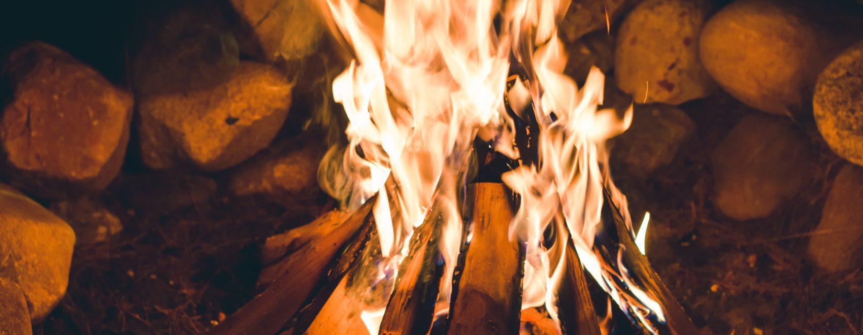 Burning campfire surrounded by rocks