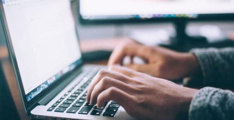 Person typing on laptop.