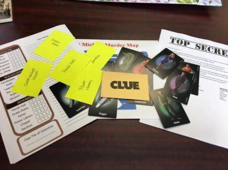 Materials from the board game Clue on a table.