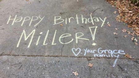 A message on a driveway in chalk, "Happy Birthday Miller! Love Your Grace Family"