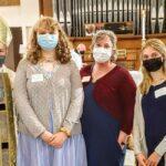 A bishop and three women, all masked.