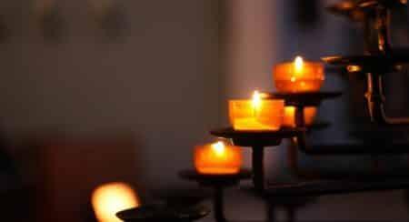 Several lit tealight candles on candle holders