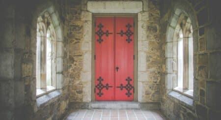 Red double doors on a stone building