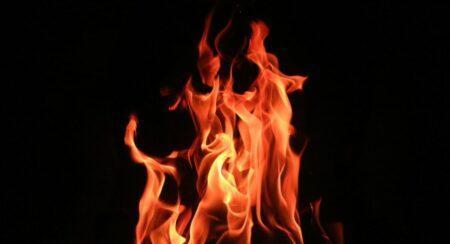 A red, orange, and yellow fire in front of a black background