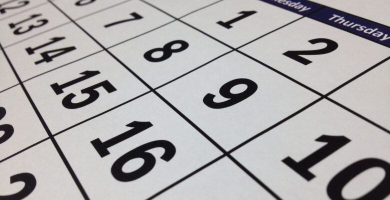 Close-up diagonal view of black-and-white monthly numbered calendar, showing numbers 1, 2, 6, 7, 8, 9, 10, 12, 13, 14, 15, 16
