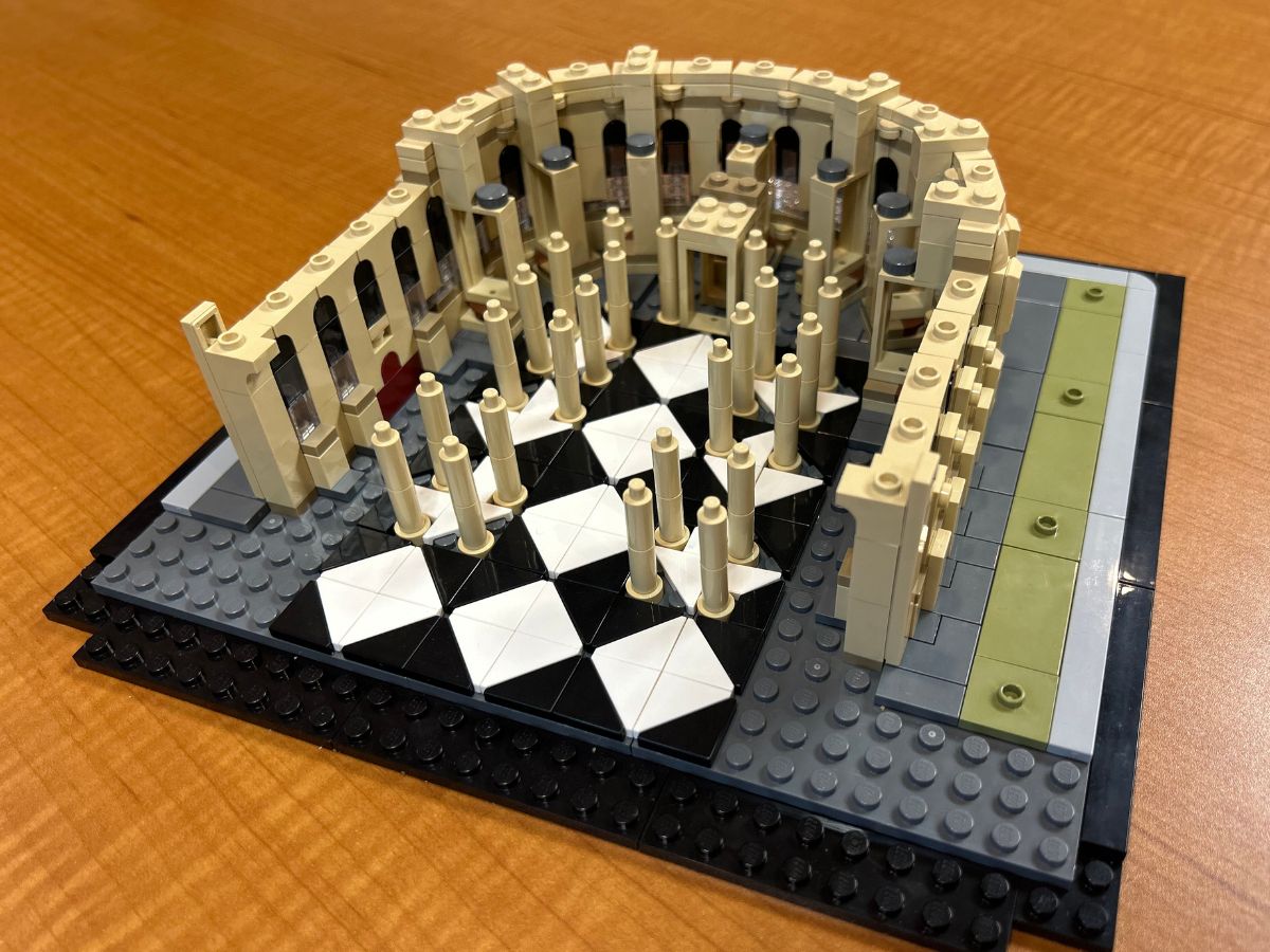 Angled aerial view of foundation for the Lego Notre Dame Cathedral on a tan wood surface