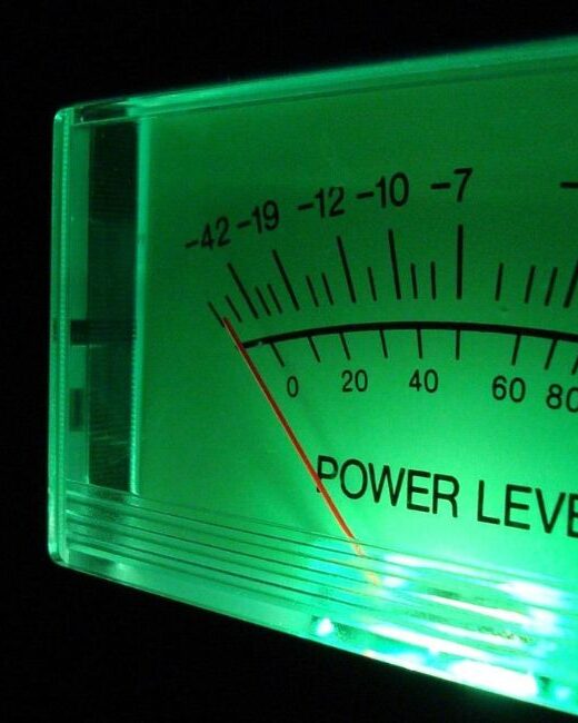Close-up of volume level meter with green front lighting against a dark background