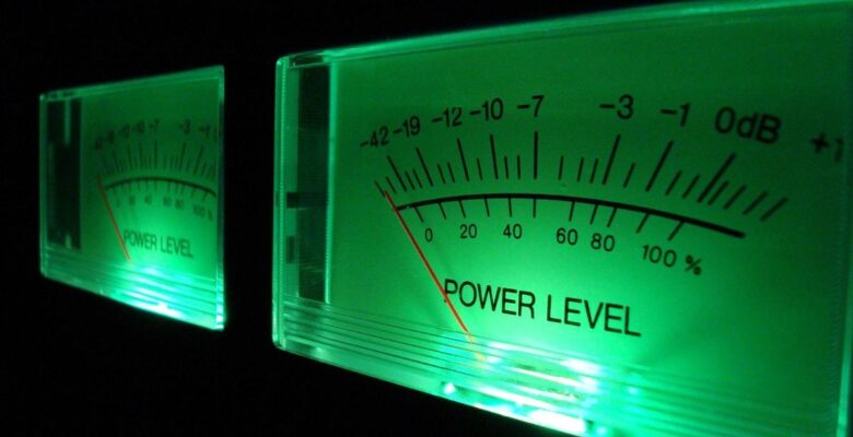 Close-up of volume level meter with green front lighting against a dark background