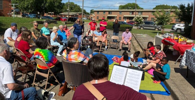 The Abbey community in Alabama worshipping outside in their neighborhood