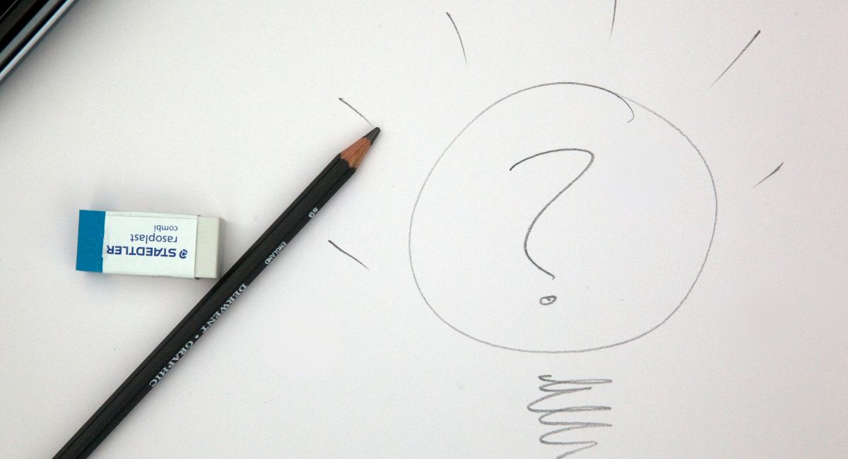 Gray pencil drawing of question mark in a circle surrounded by short rays along the top and a spiral squiggle at the bottom with a white eraser and gray pencil to the left on an off-white background