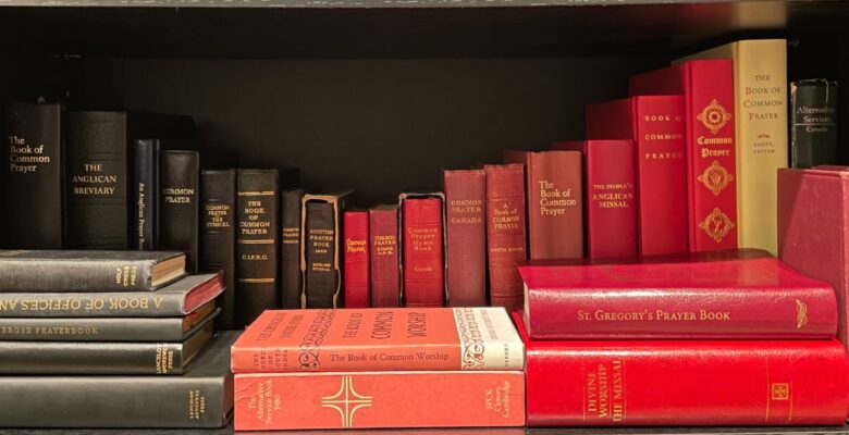 A collection of various editions of the Book of Common Prayer, derivatives, and associated liturgical texts on a dark brown bookshelf