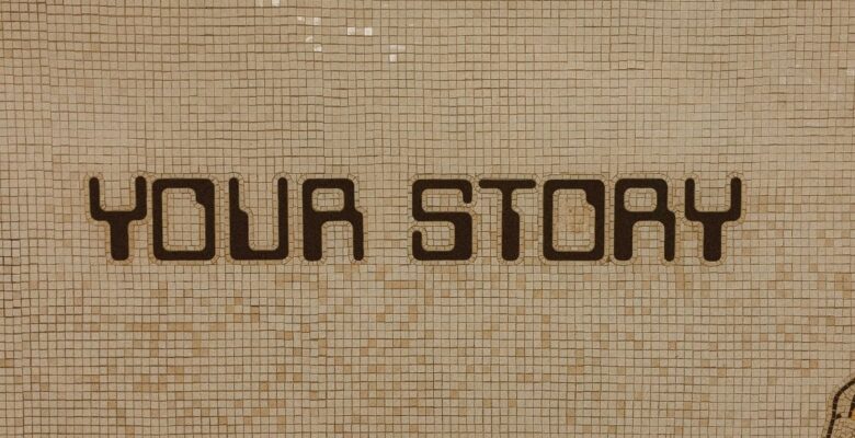 Text that says "YOUR STORY" in dark brown vintage video game letters on a beige tile wall